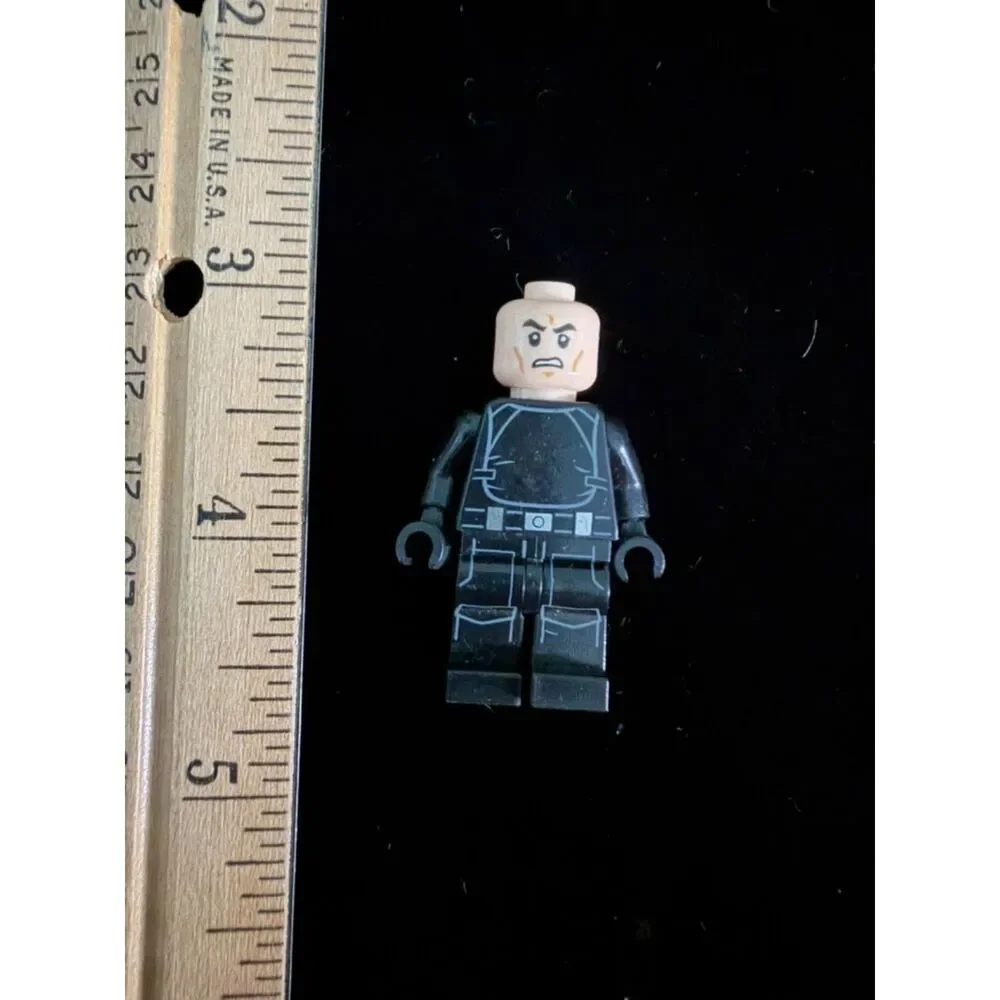 LEGO minifig with black tactical suit and and angry bald head
